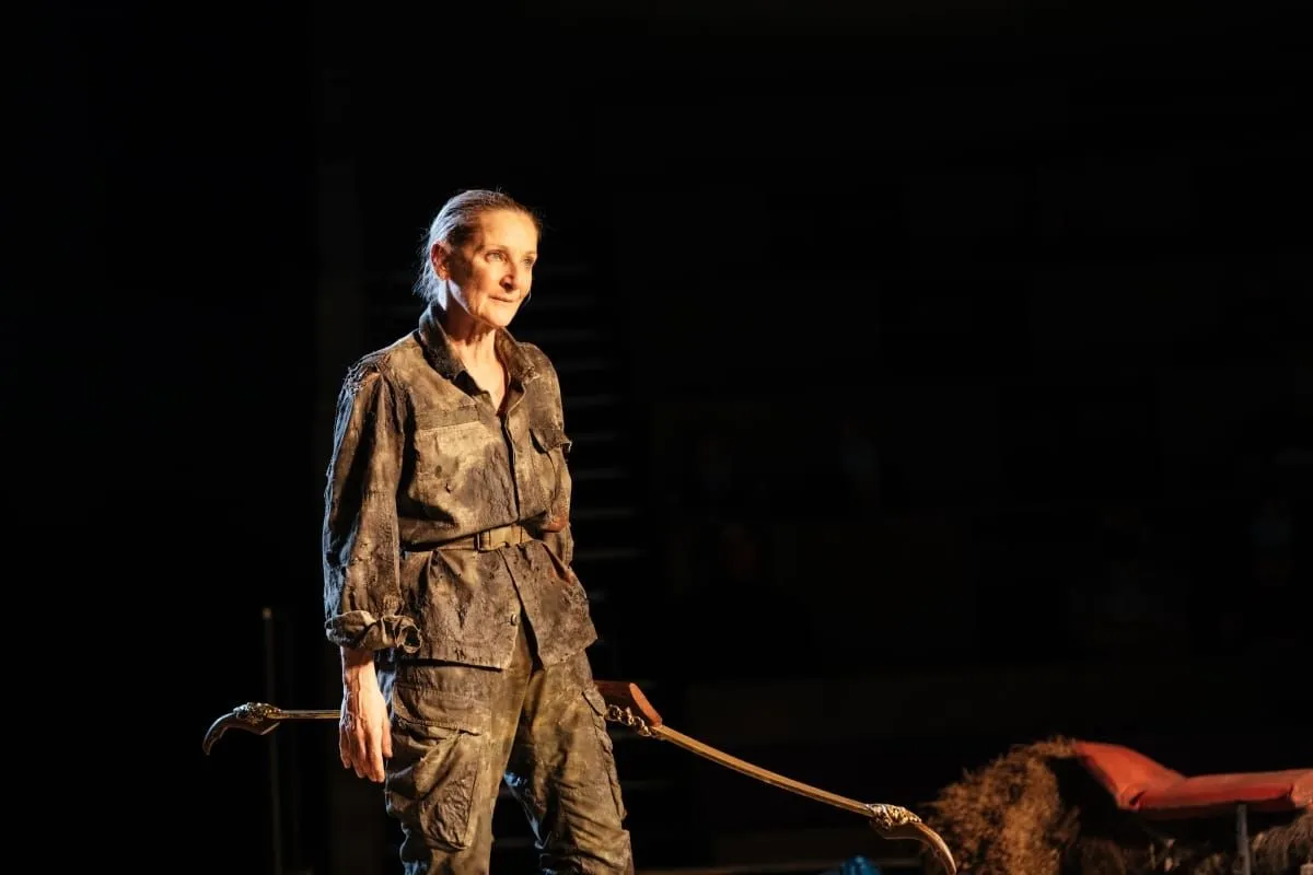 Philoctetes (Lesley Sharp) holds the Bow of Hercules.